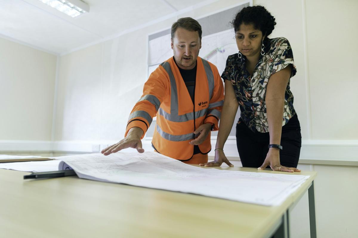 A tradesperson going over plans with a client